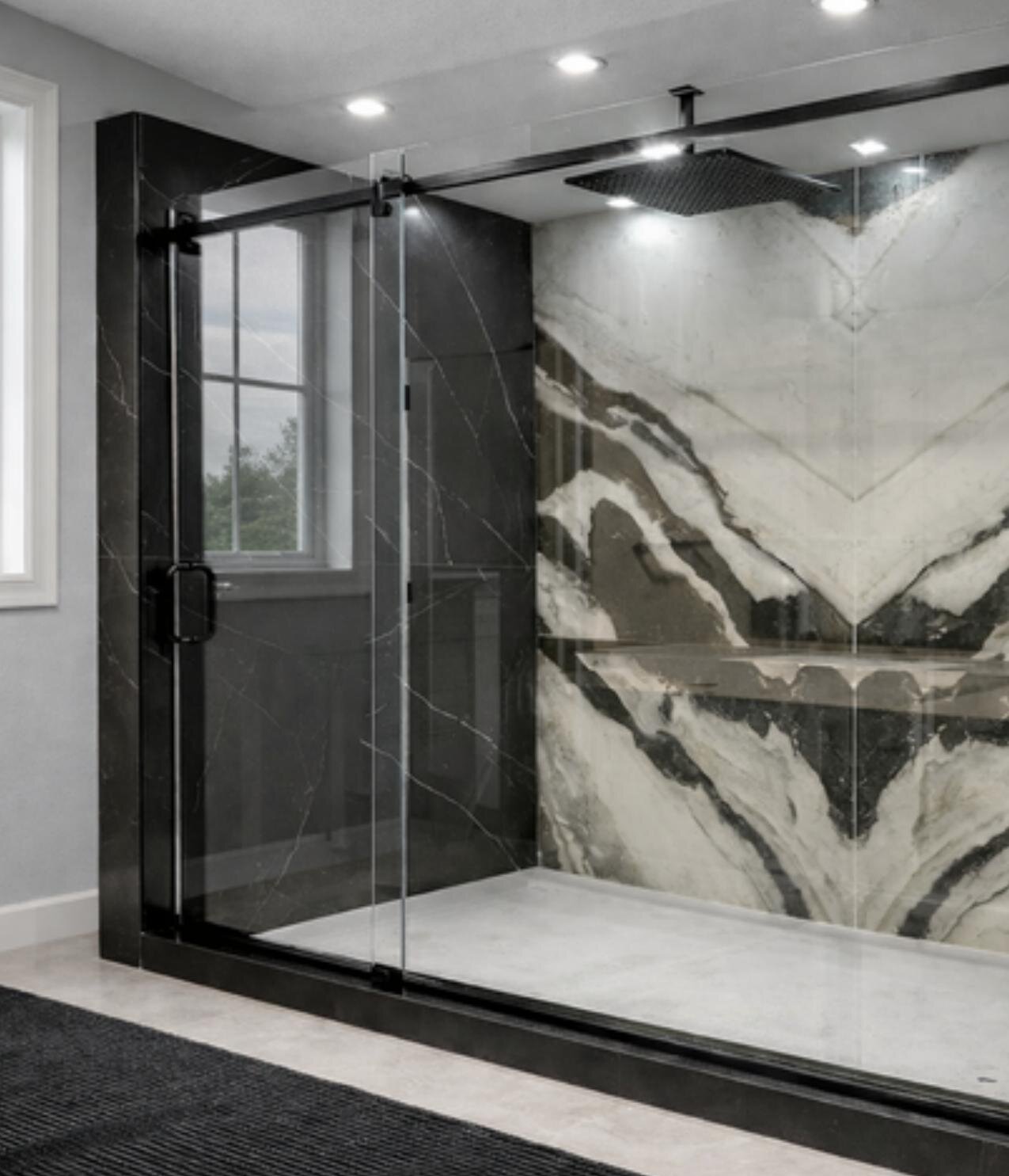 Frameless shower enclosure with marble